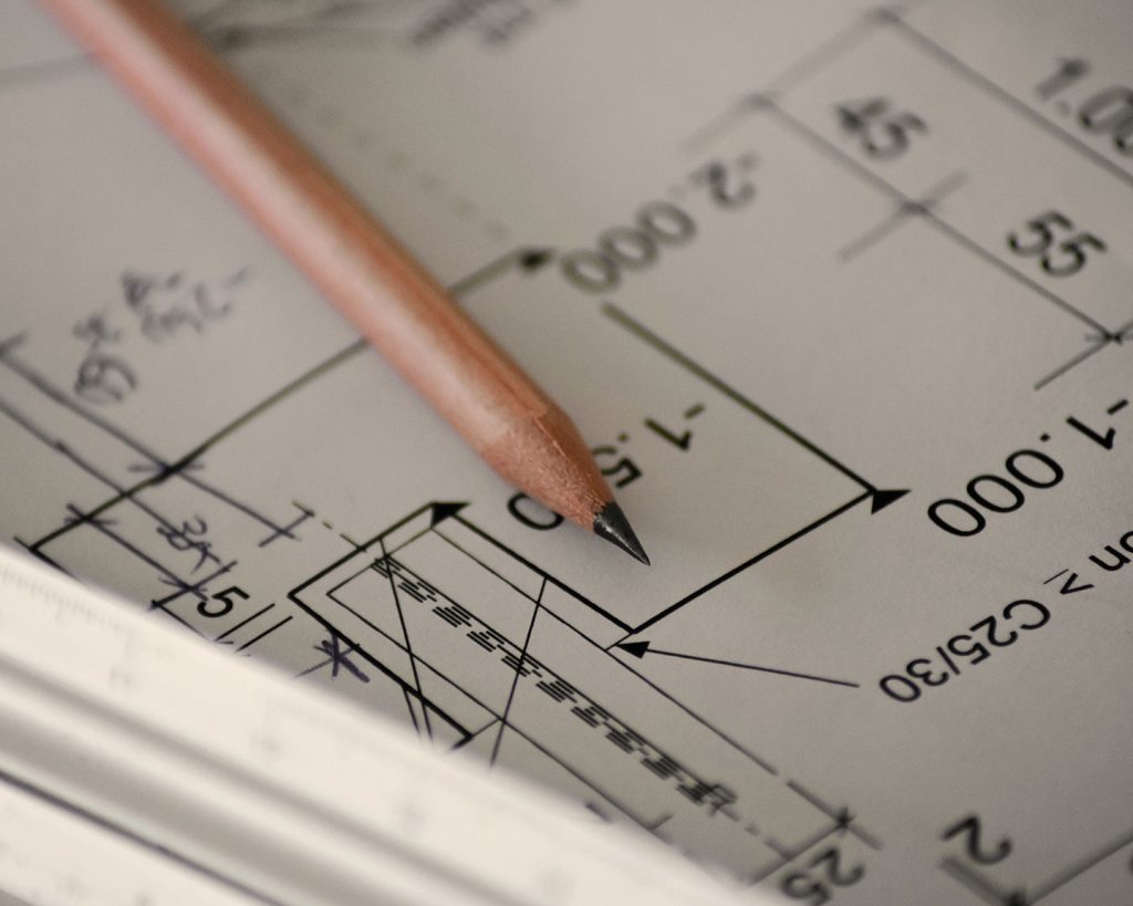 Close-up of architectural blueprints, representing Kali's engineering background